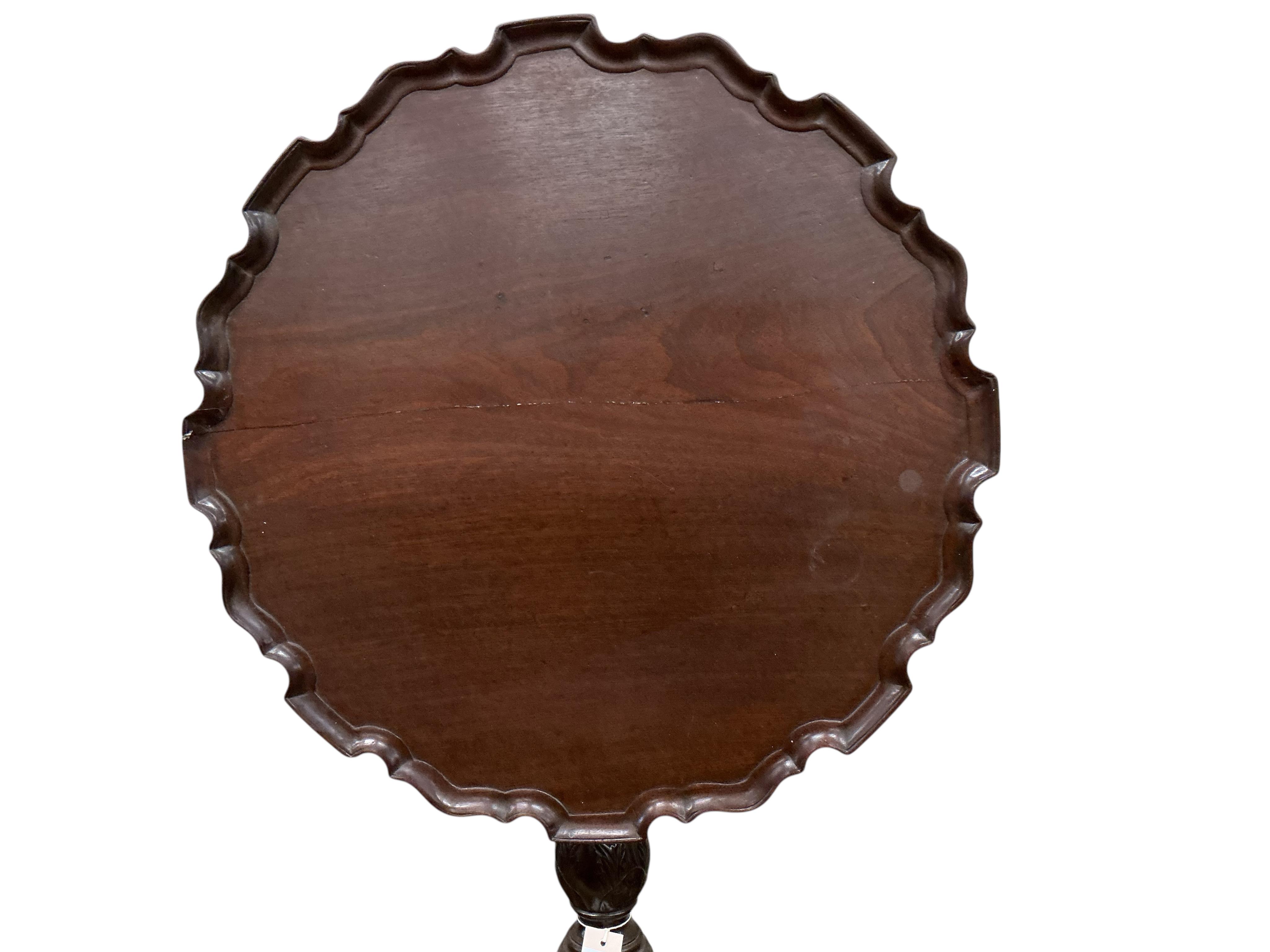 A George III circular mahogany piecrust tilt top bird cage tripod tea table, diameter 64cm, height 71cm (repair to top)